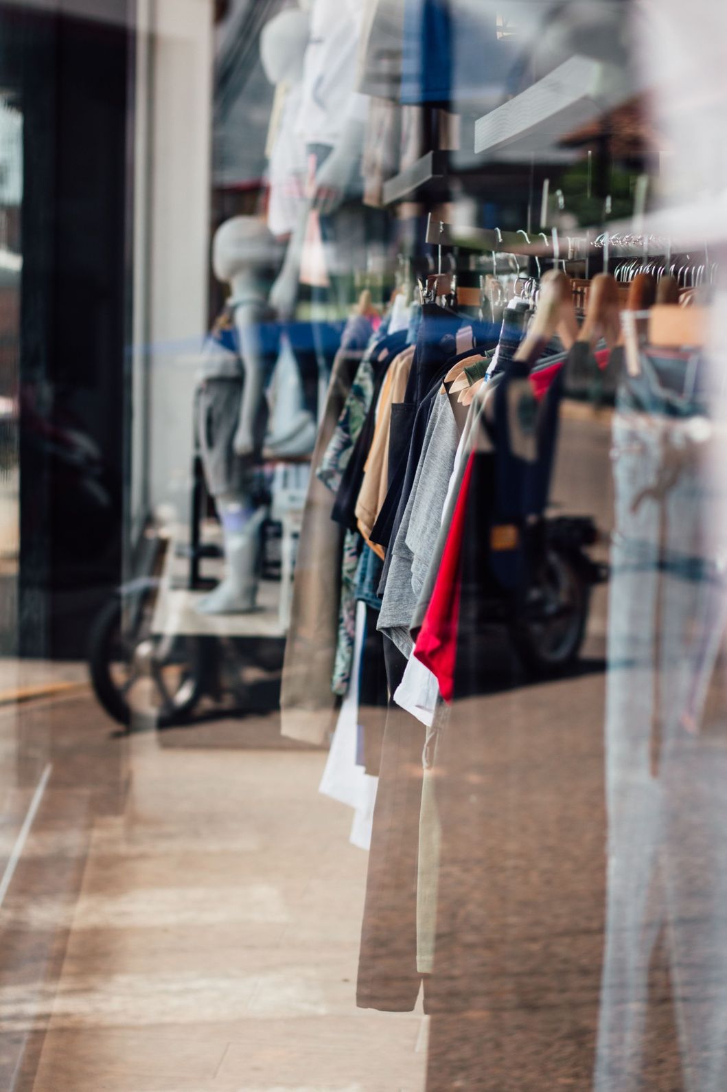 Picture looking into windows on storefront shop with merchandise on display