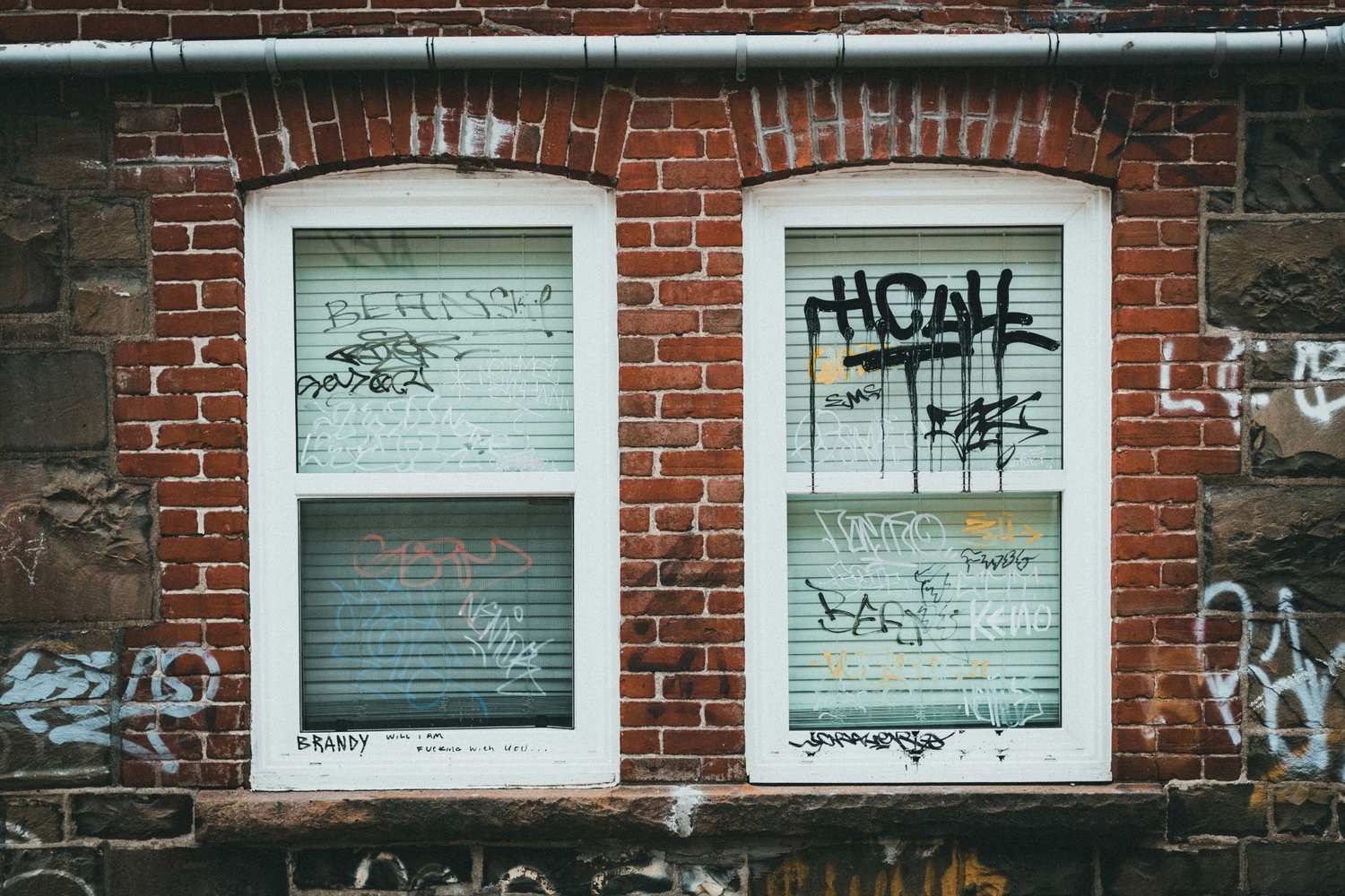 2 smaller windows covered by graffiti