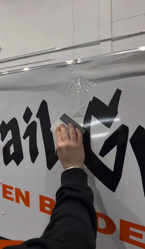 Installing custom signage on mobile detailing hitch in Fraser, Michigan