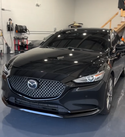 Results after 2-step paint correction and coating on black Mazda sedan